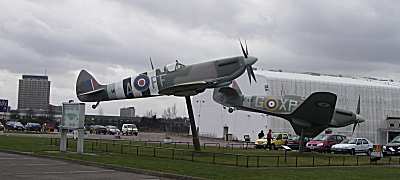 Two aircraft on display at the entrance to Hendon Aircraft Museum.