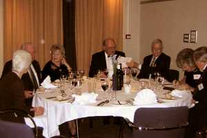 Diners sitting and talking around a dining table.