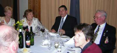 Men and women sat around a dinner table.